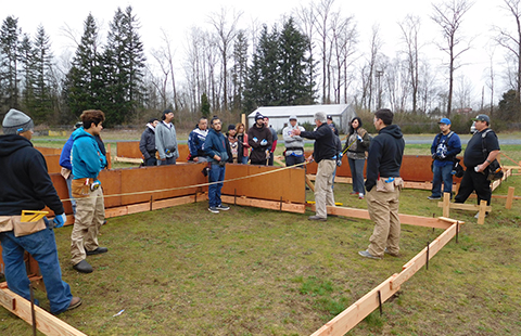 Tulalip Vocational Training Center students building a concrete pad.